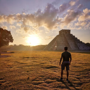 A man standing to the sunrise in Chichen Itza in Gay Tours in Yucatan Riviera Maya